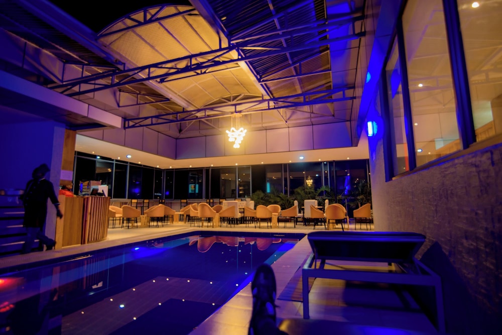 Rooftop pool and lounge at Wintana Apartments with blue evening lighting